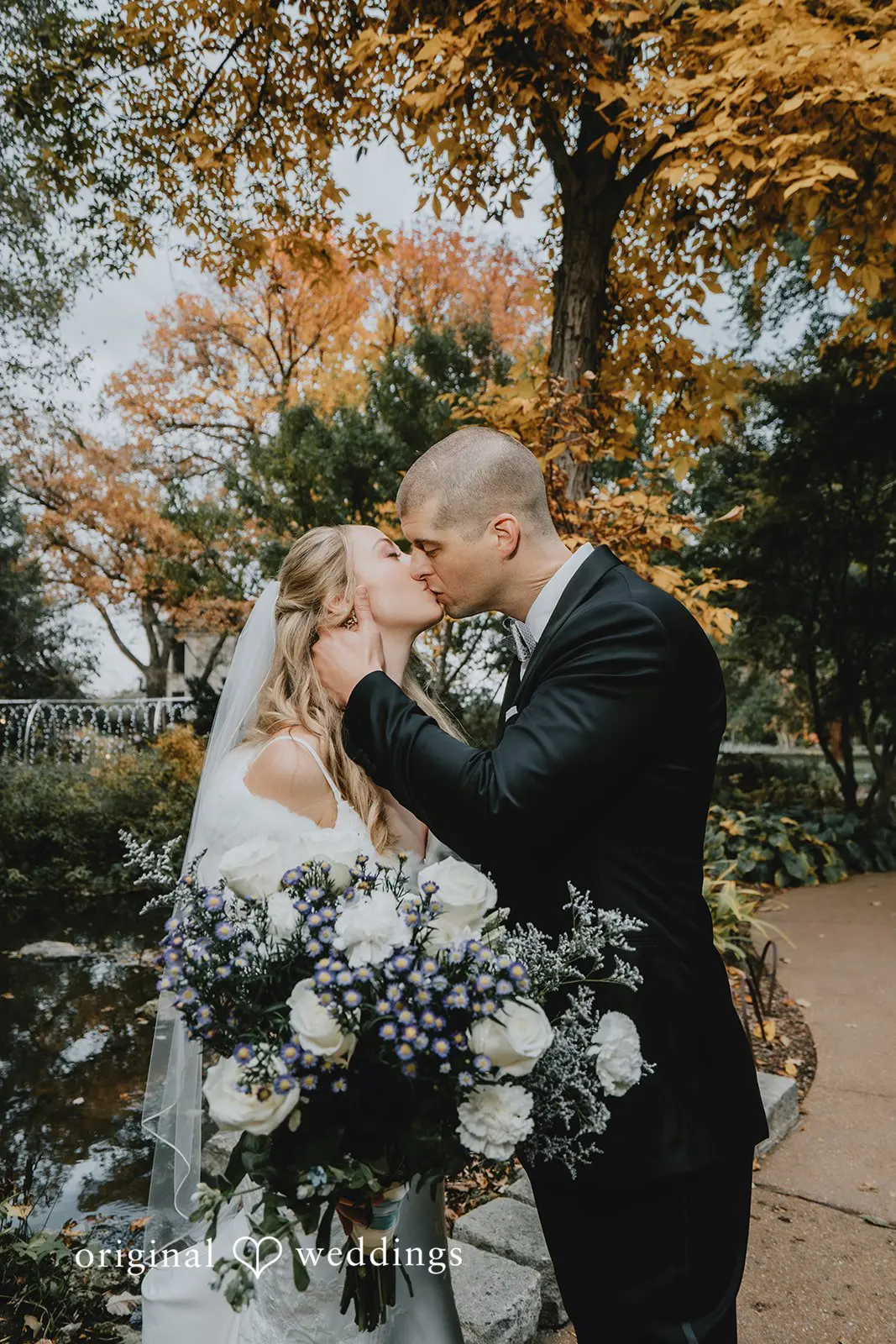 The bride and groom share a kiss in the garden