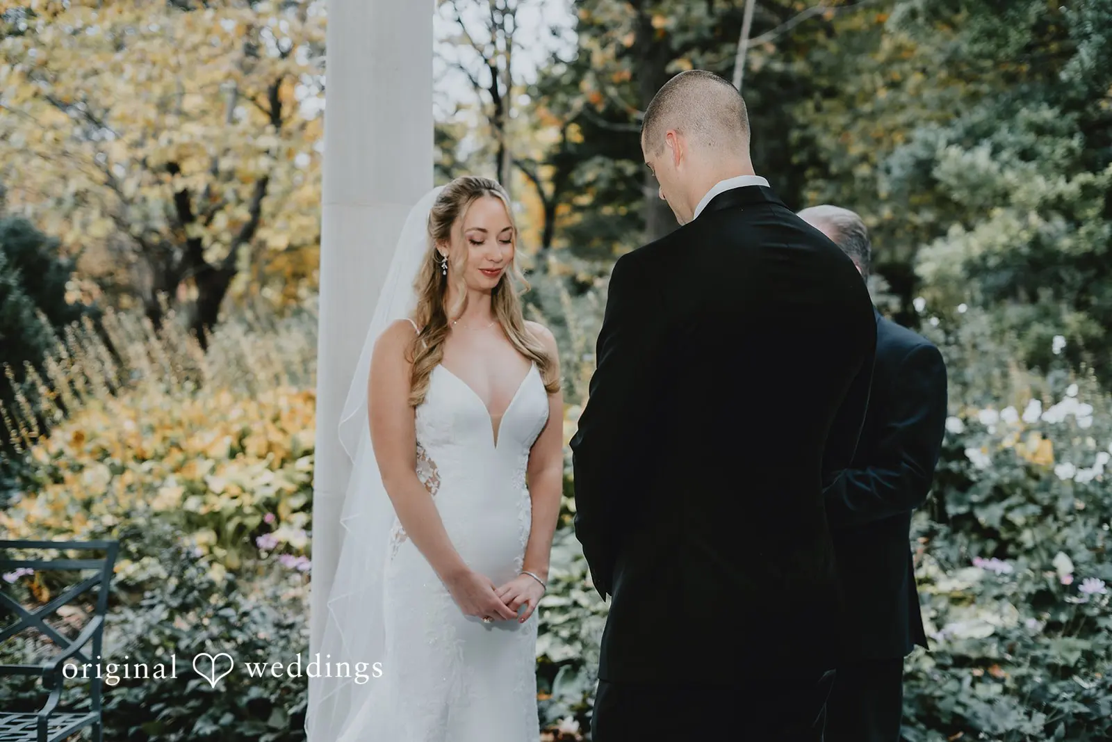 The bride and groom about to exchange marital vows at St. Louis Botanical Gardens