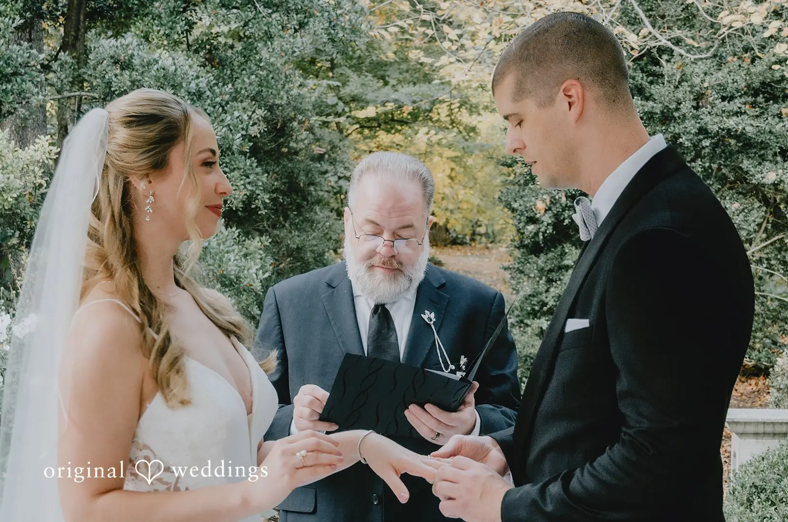 The moment the groom puts a ring on the bride's finger at their Missouri wedding venue