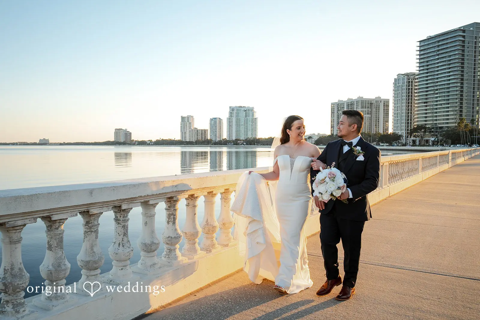 Bride and groom walking together along the Bayshore Boulevard waterfront near Tampa Garden Club