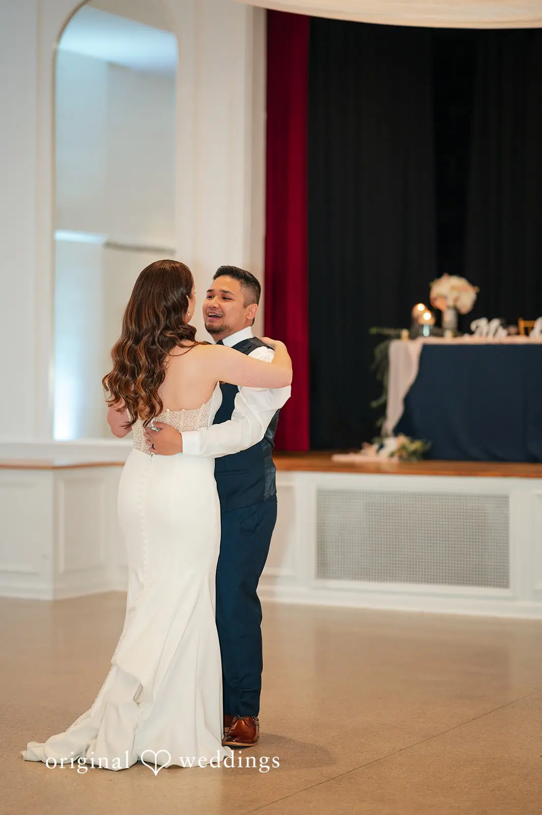 Bride and groom sharing their first dance in the reception ballroom