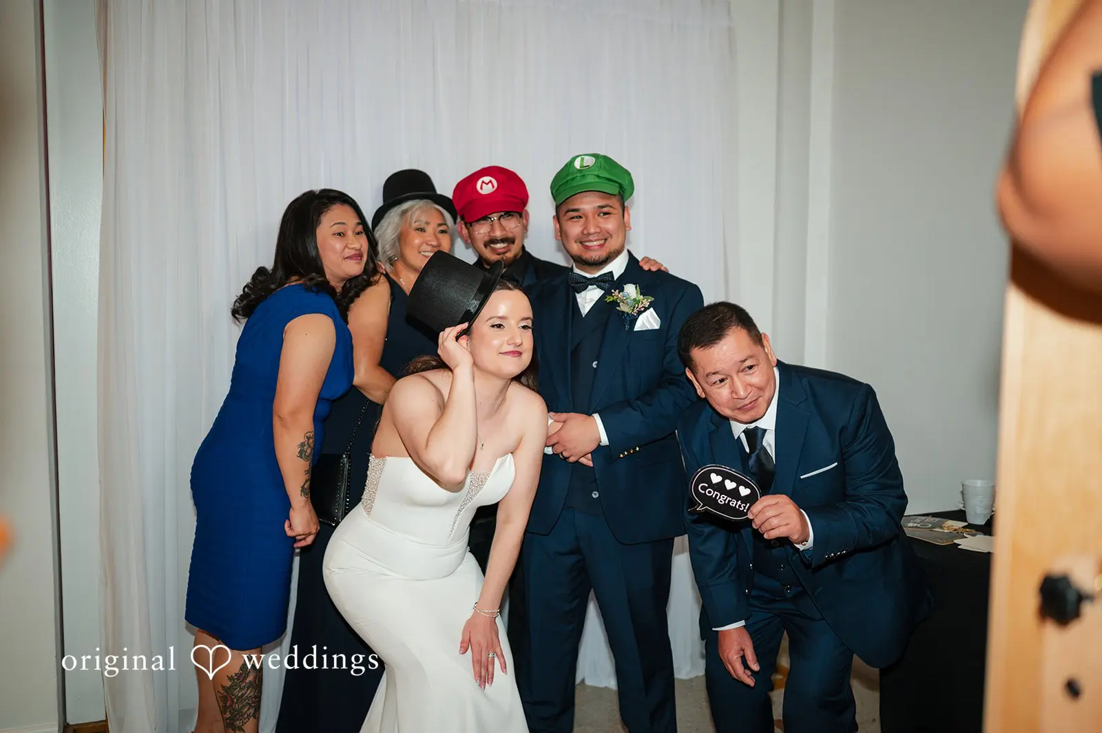 Guests and the bride and groom taking fun photos together