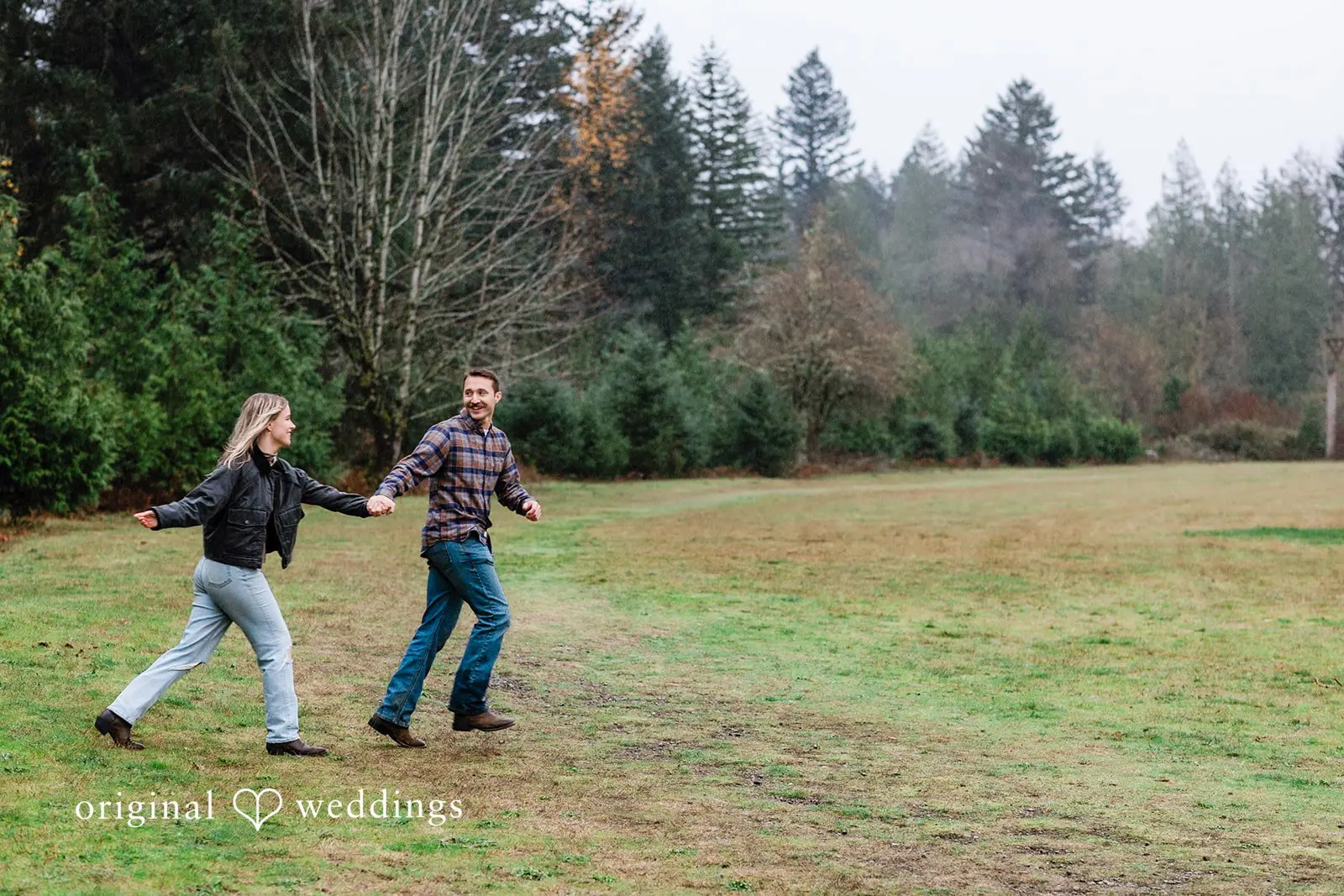 A portrait of the couple running through the fields of Tanner Landing Park