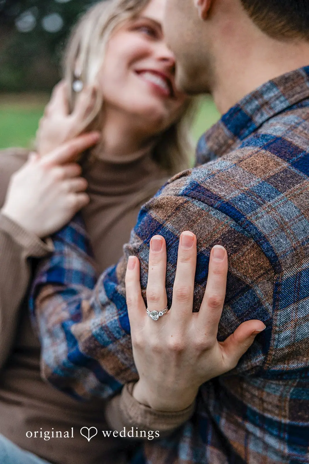 A romantic portrait of the couple showing the bride's engagement ring