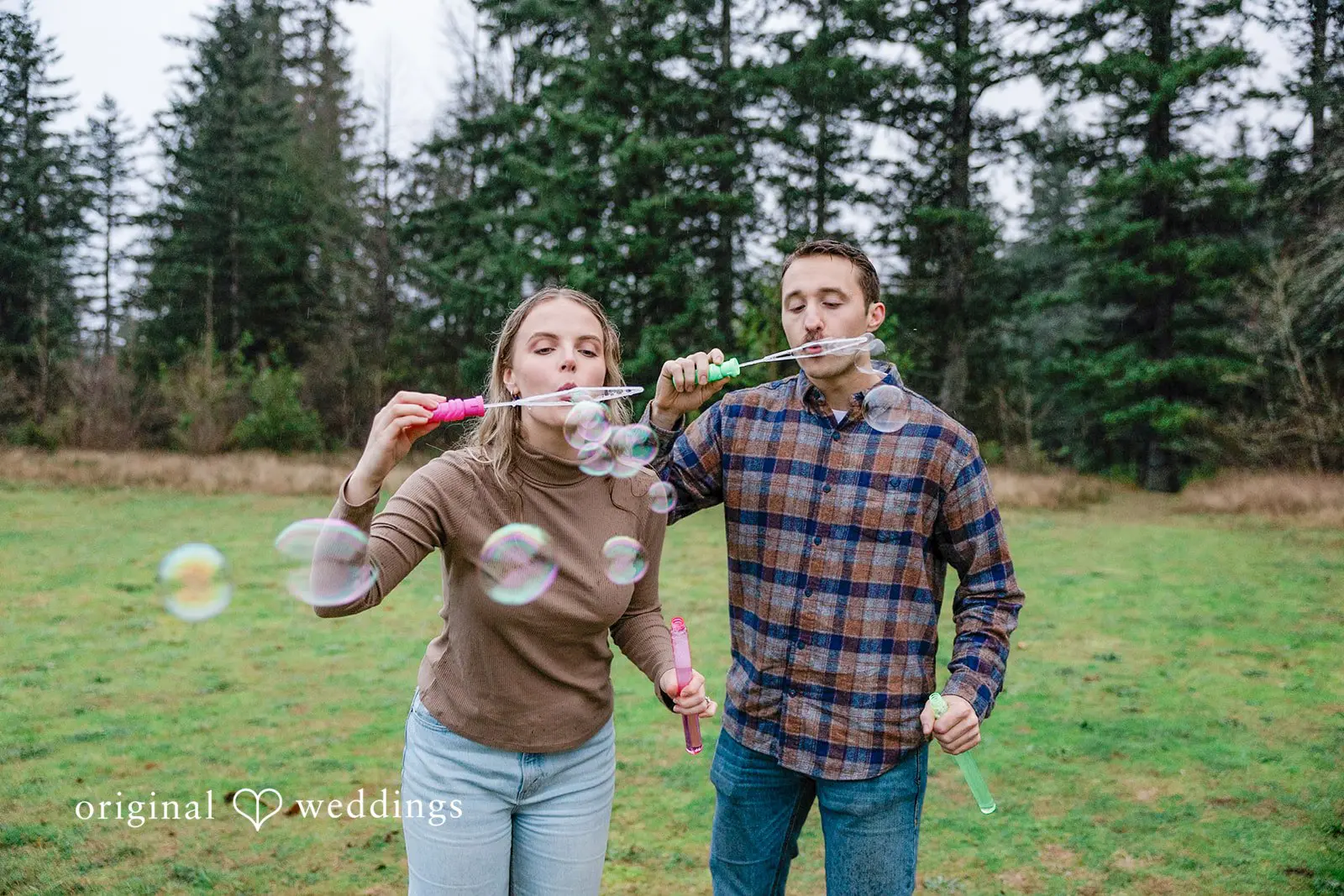A fun portrait of the couple blowing bubbles into the air