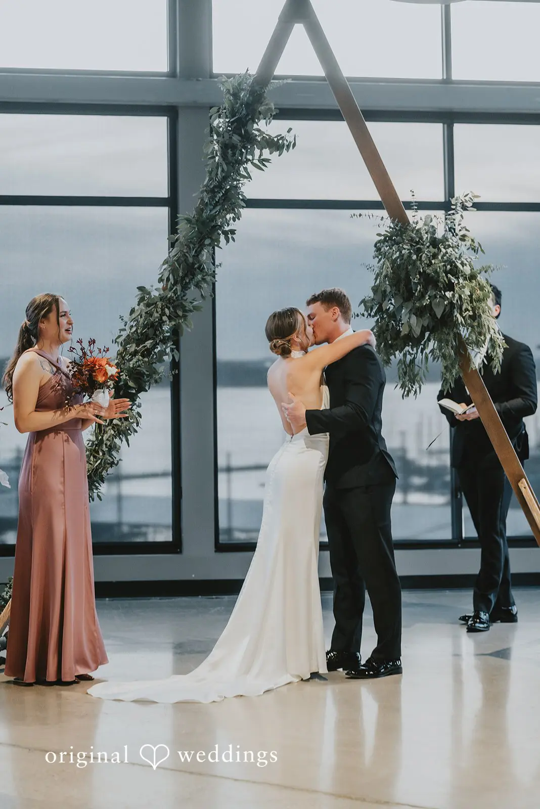 The bride and groom share their first kiss