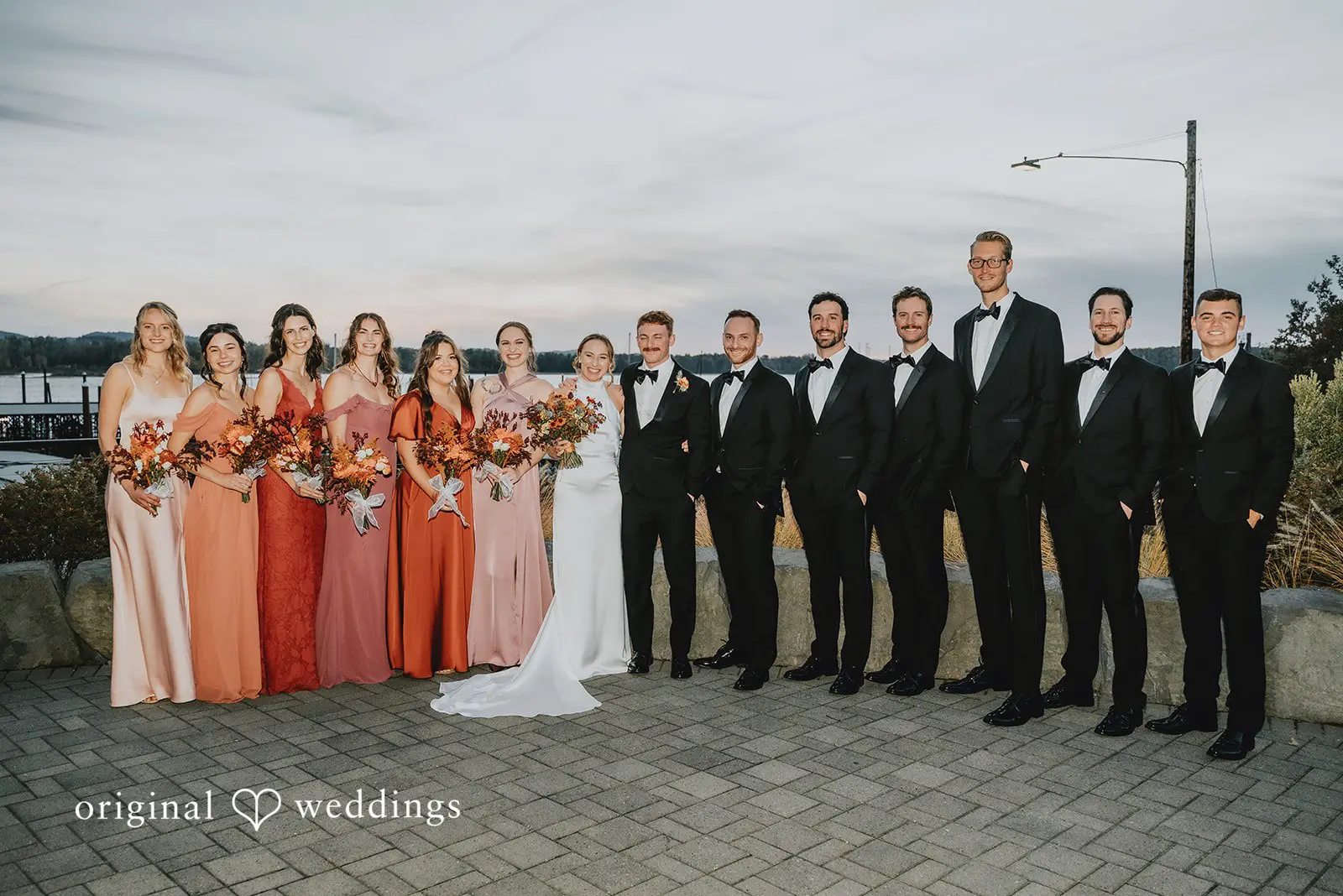 A portrait of the bride and groom with their bridal party at The Black Pearl