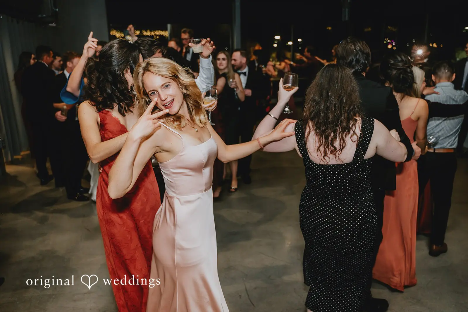 Happy guests dancing around the reception hall