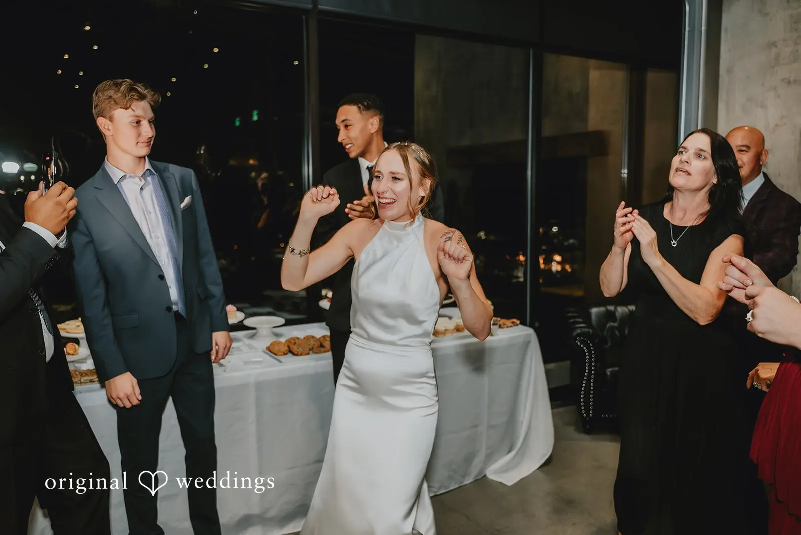 The bride is having a happy time with guests at the wedding reception