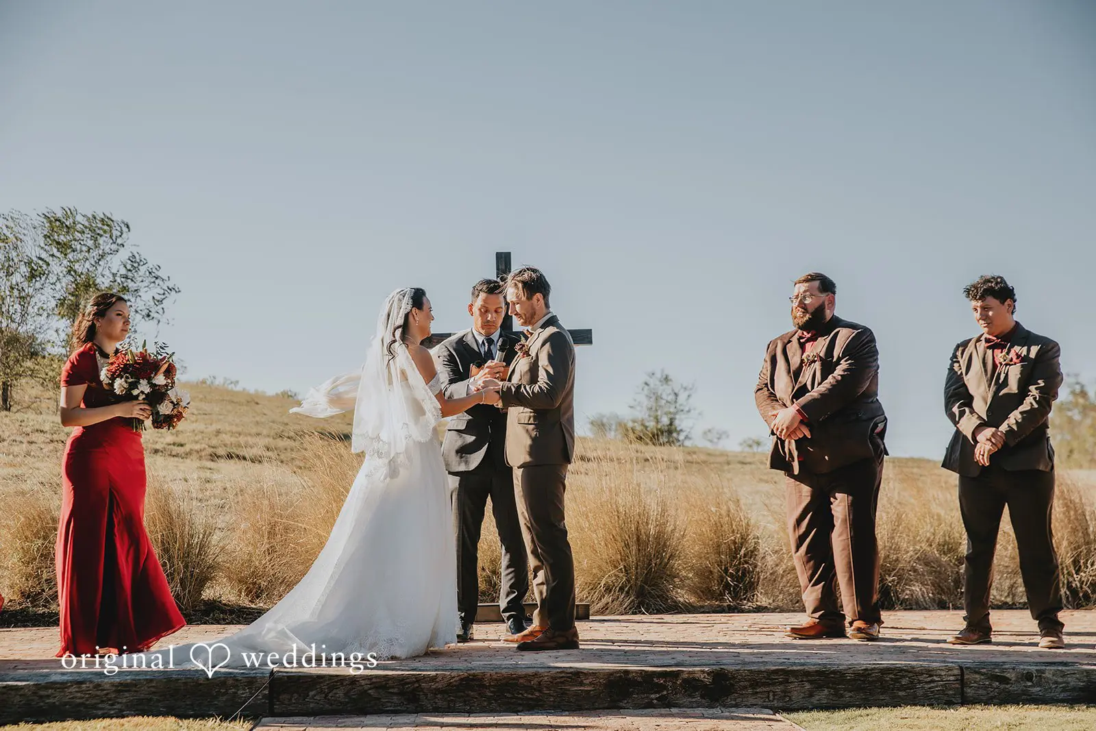 The bride and groom exchange rings at the Two Wishes Ranch wedding ceremony