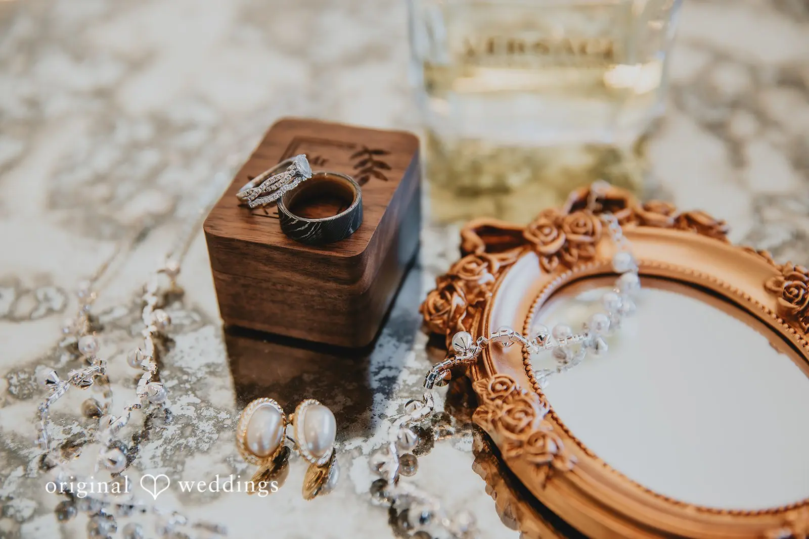 A detail shot of the wedding rings and accessories at Two Wishes Ranch