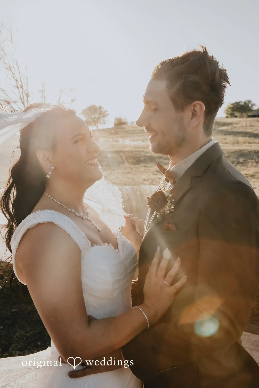 A romantic portrait of the couple wrapped in the evening sun