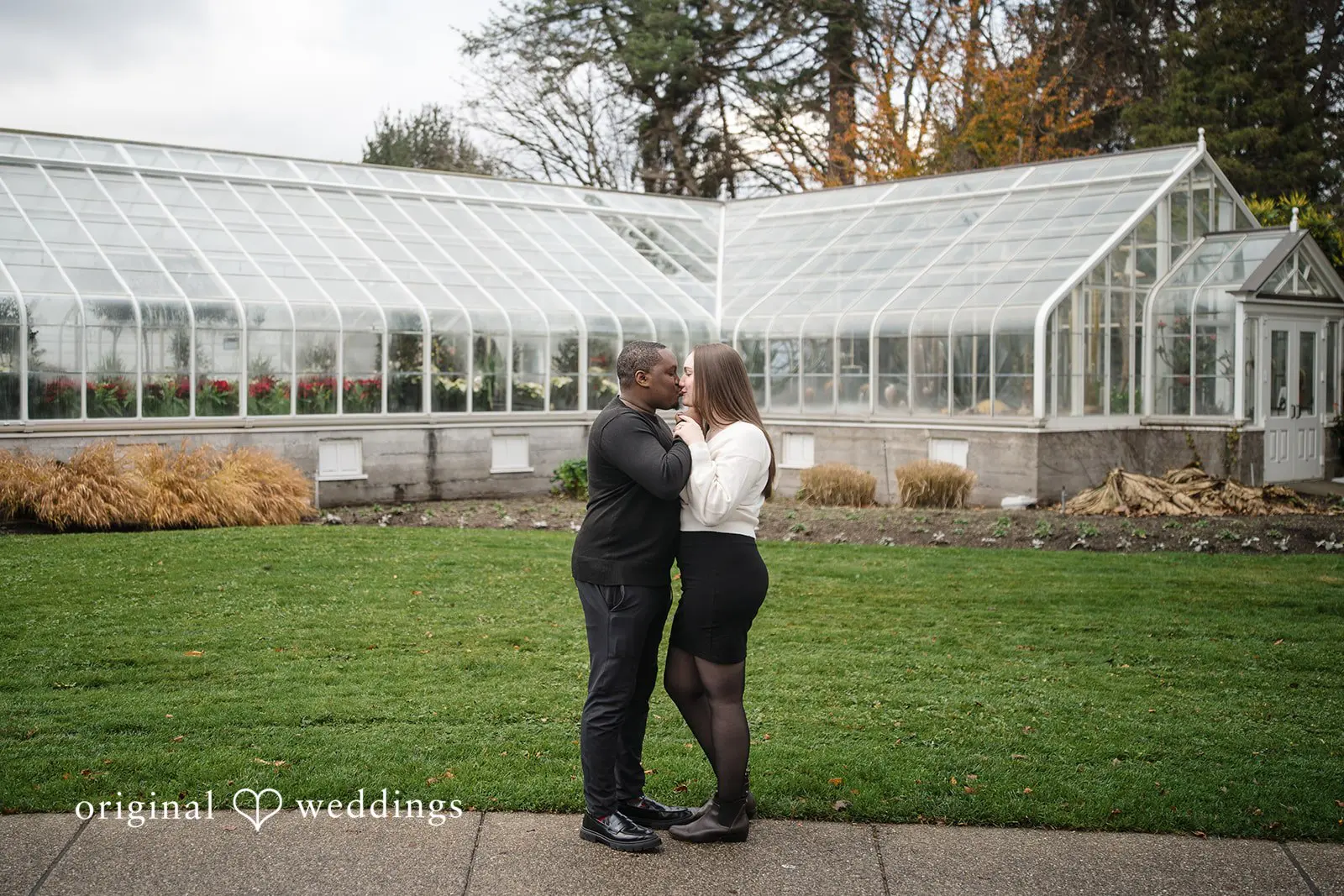The couple shares a kiss at Volunteer Park's outdoor area