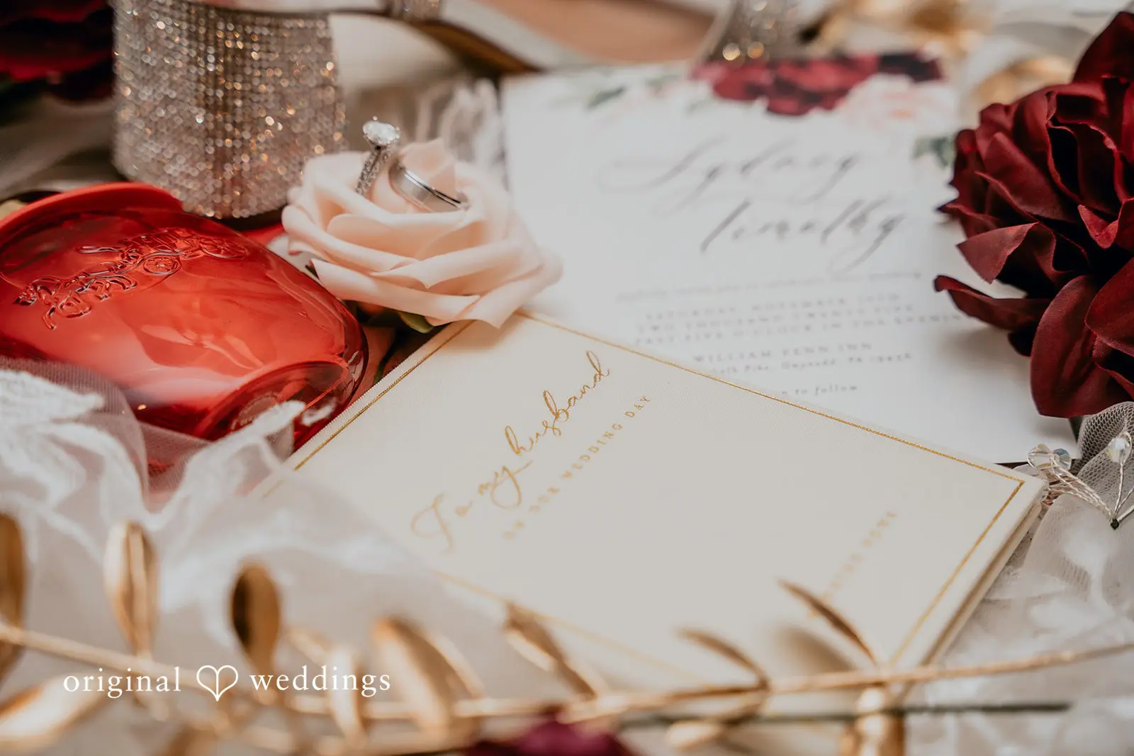 A detail photo of the wedding rings, florals, etc.