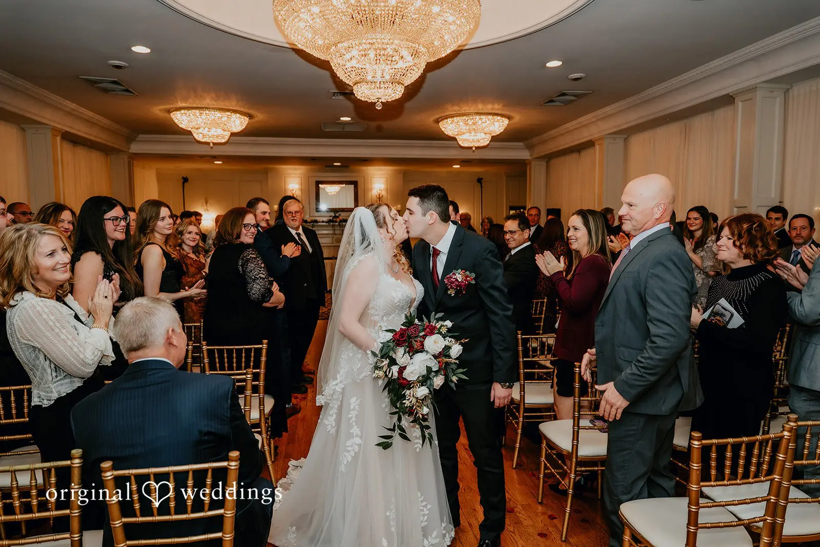 The bride and groom seal their exit with a romantic kiss