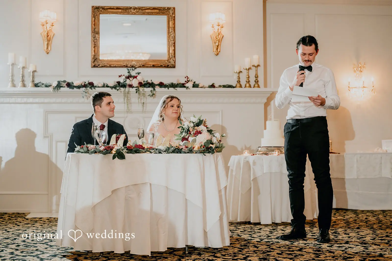 The bride and groom seated at their wedding reception