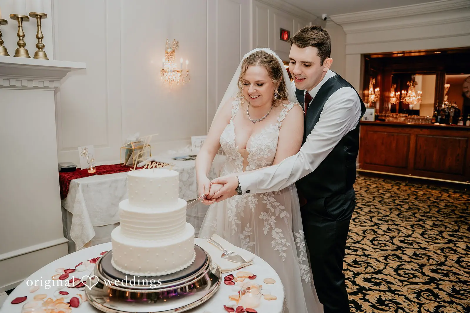 The couple cuts their wedding cake
