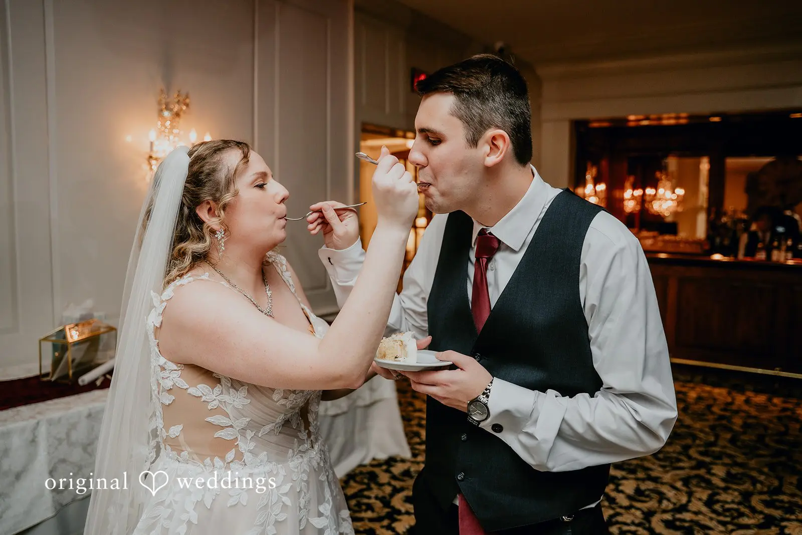 The couple feeds each other at their wedding reception