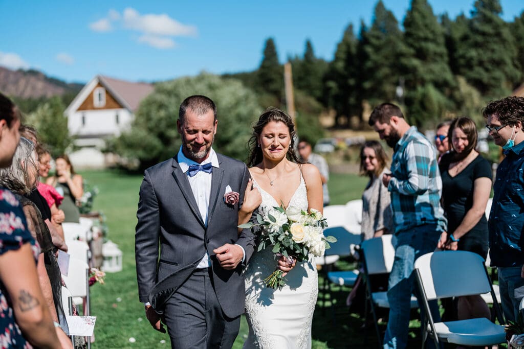 Bride and her Father walking down the idle at a Cattle Barn Wedding
