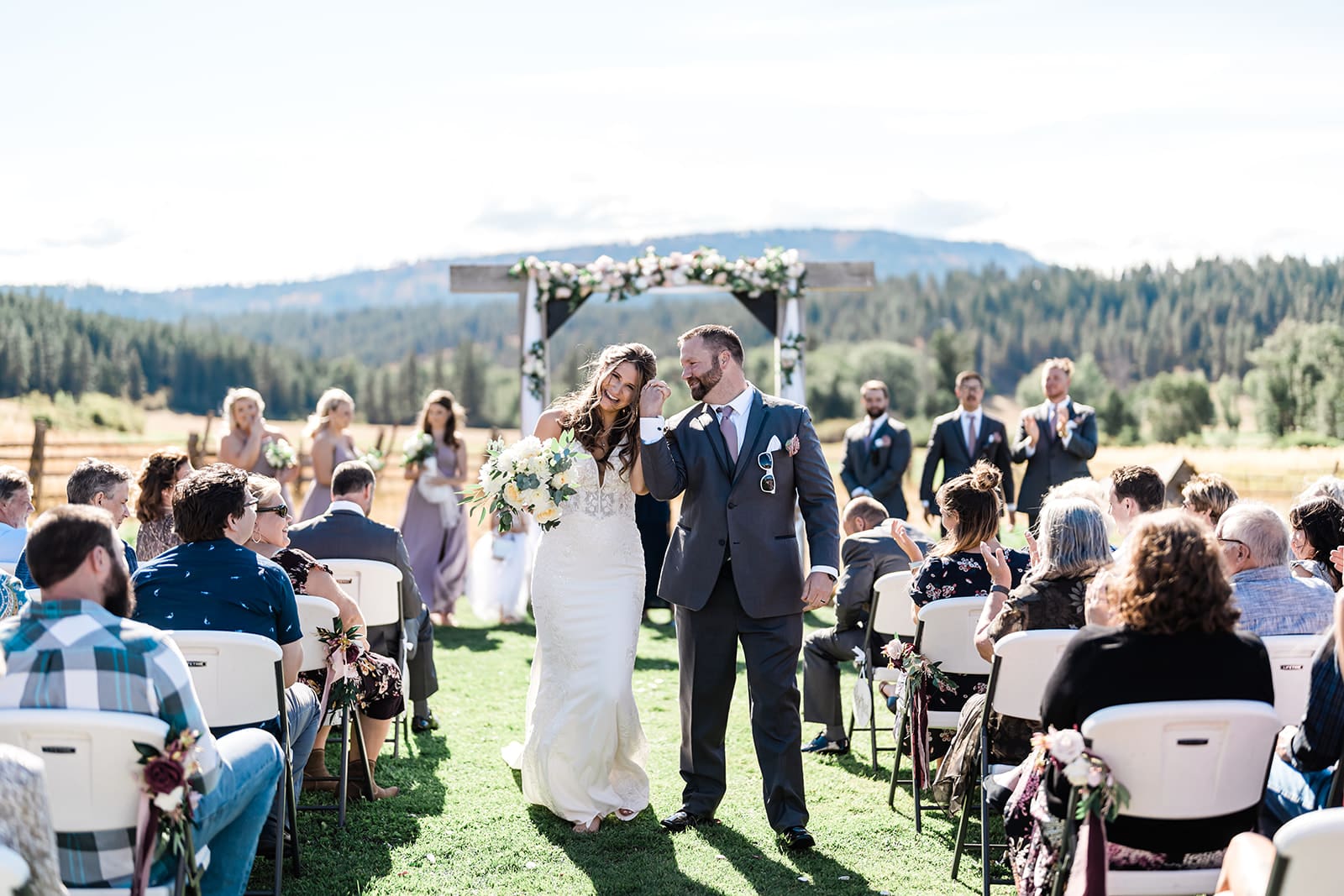 Bride and Groom walking down the isle Cattle Barn Wedding down the isle at a