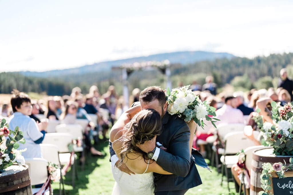 Bride and Groom walking down the isle at a Cattle Barn Wedding