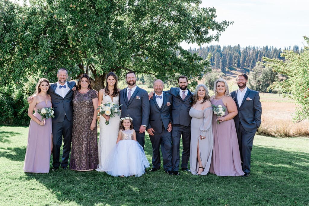 Couple and bridal train at a Cattle Barn Wedding