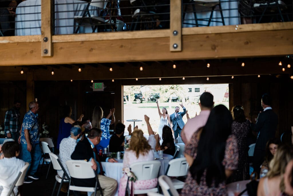 Couple entering the wedding party venue of a Cattle Barn Wedding