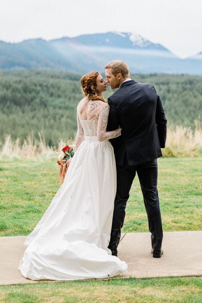 Bride and groom kiss outside at Swiftwater Cellars