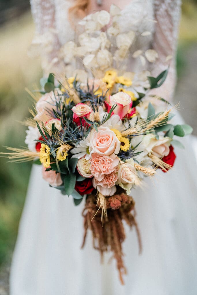 Bride holds flowers outside at Swiftwater Cellars