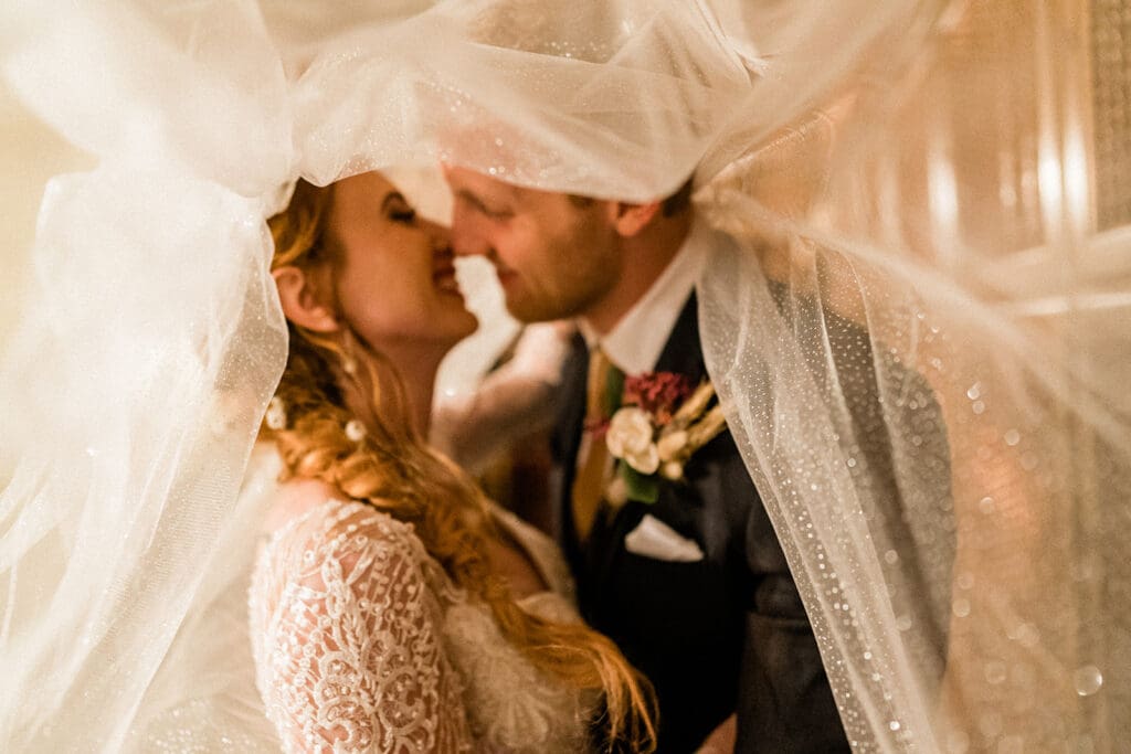 Bride and groom share a laugh inside Swiftwater Cellars