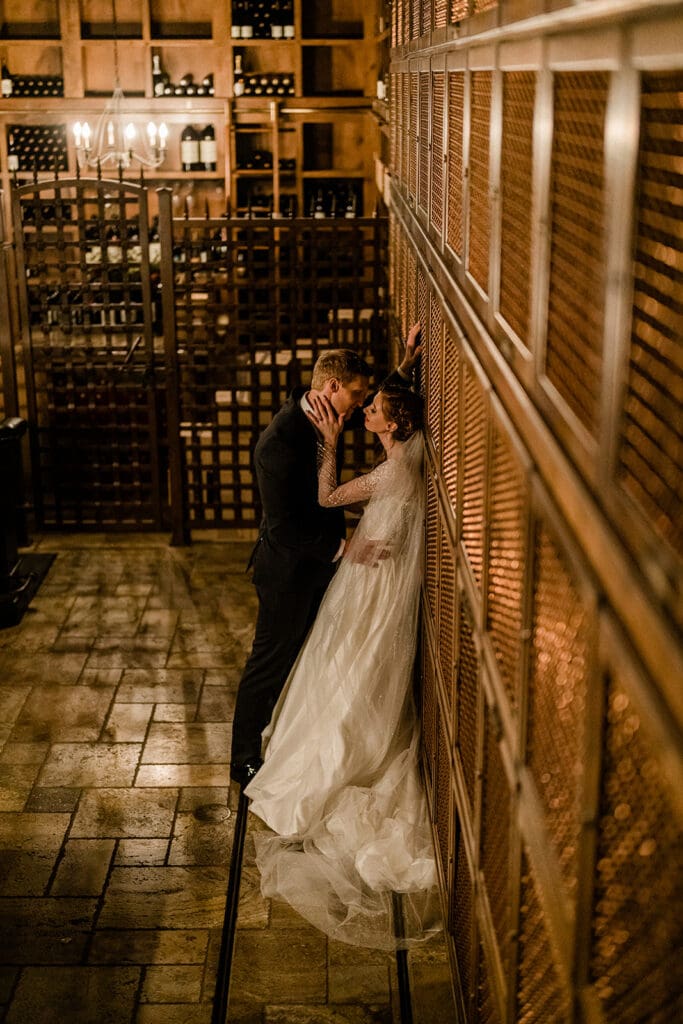 Bride and groom embrace inside Swiftwater Cellars