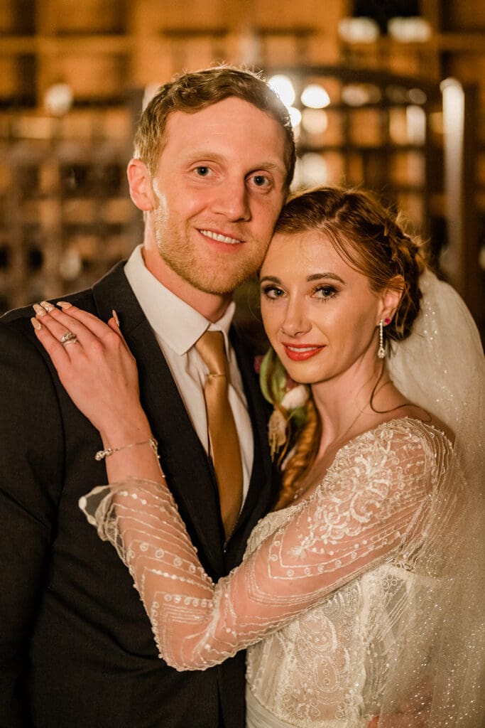 Bride and groom pose looking at the camera inside Swiftwater Cellars