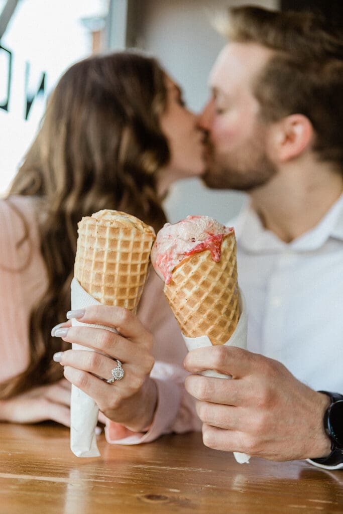Couple eating icecream at shop.