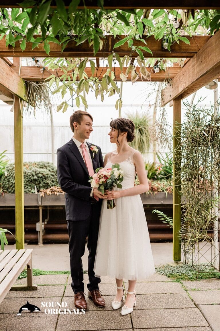 couple standing in front of open windows at Canlis restaurant in Seattle
