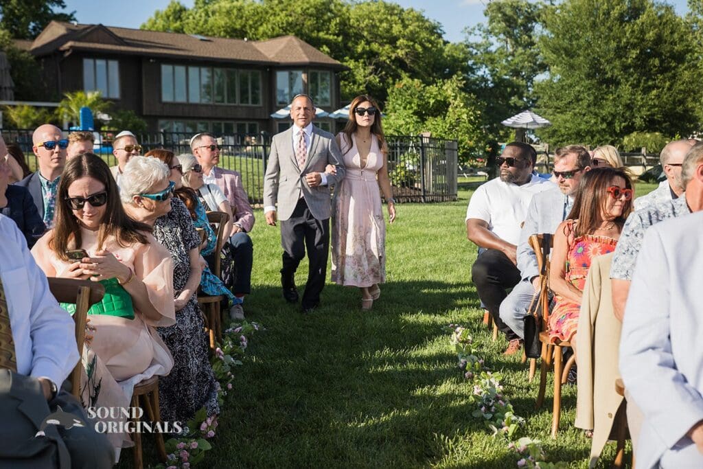 The groom's parents walk into the Private Home Wedding venue in a grand style