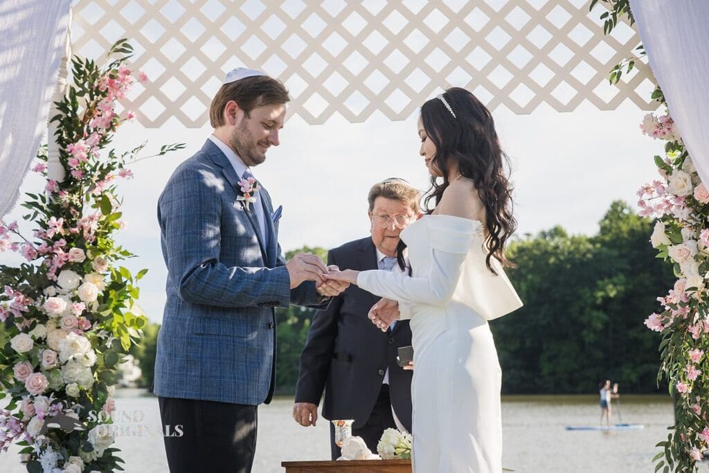 Husband and wife exchange rings at the Private Home Wedding altar