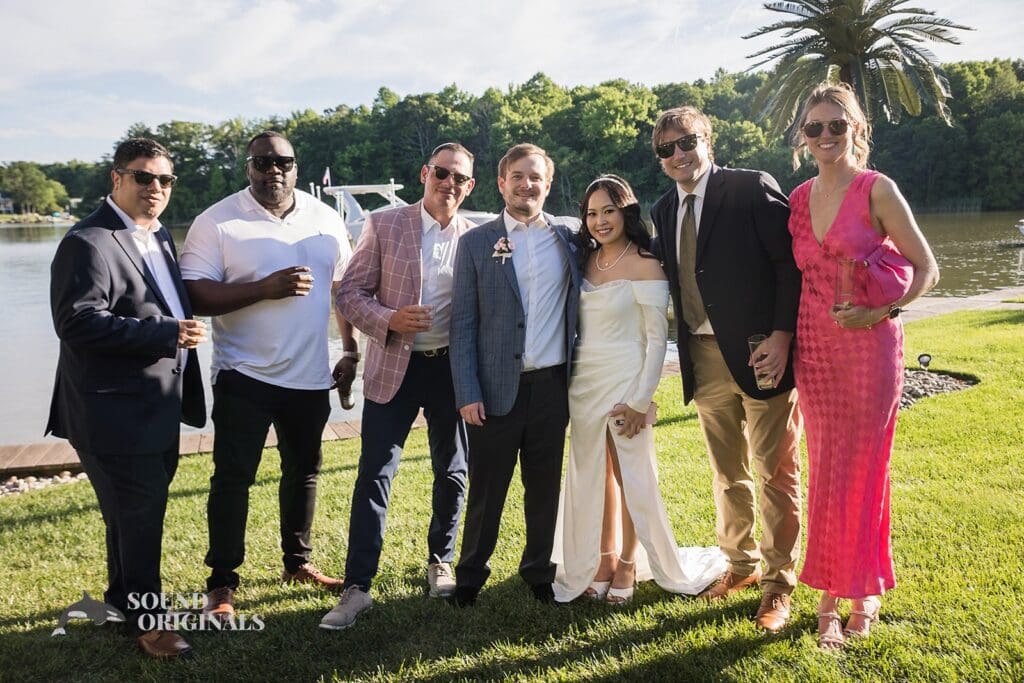 Photographer captures couple with the master of ceremony, DJ and others in the Private Home Wedding