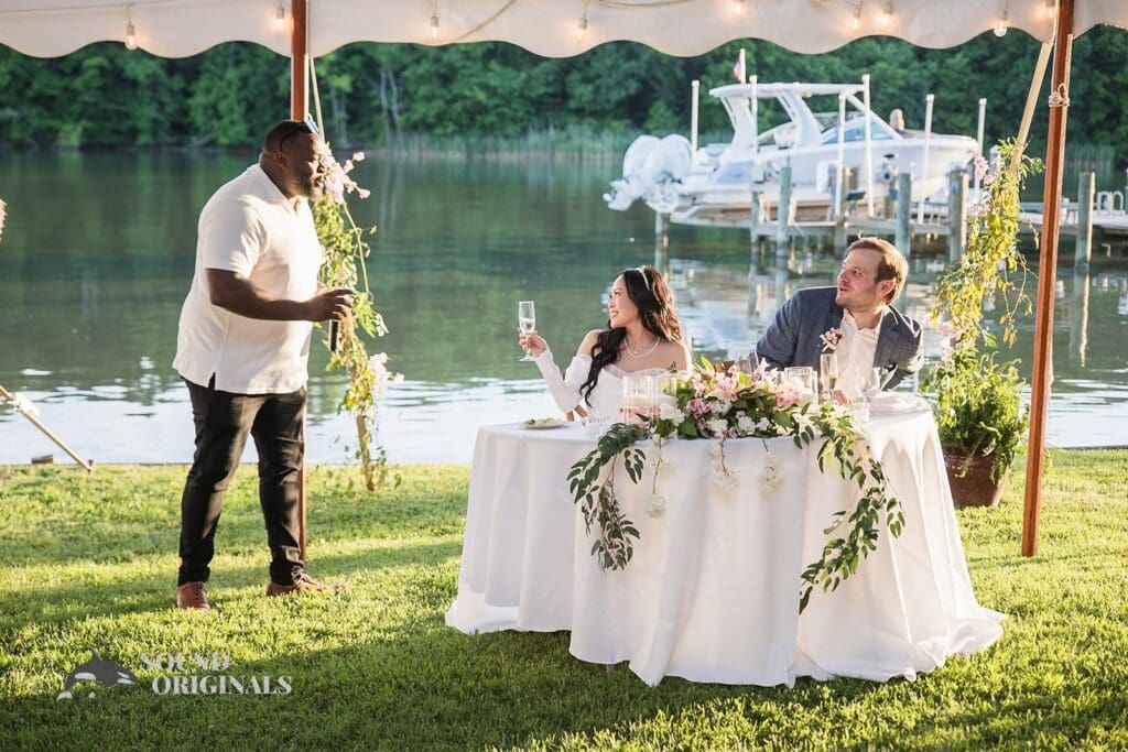 Husband and wife sit pretty on the couple's seat amidst the beautiful ambience of the wedding venue