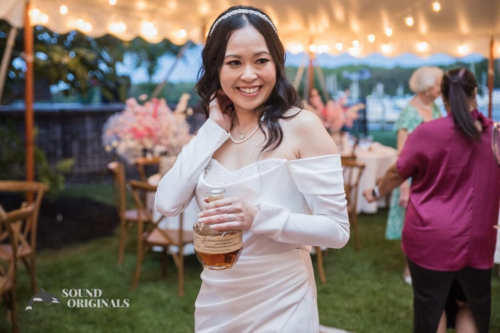 Charming bride with a classy bottle of wine in a Private Home Wedding