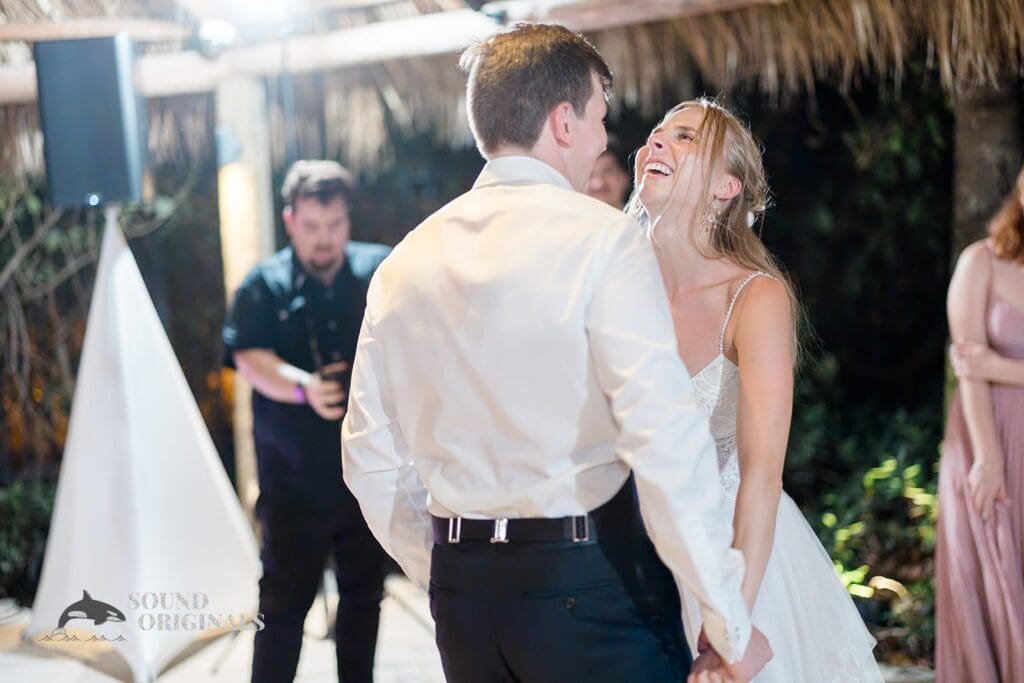 Bride and groom laughing on dance floor at The Palms Hotel & Spa Wedding