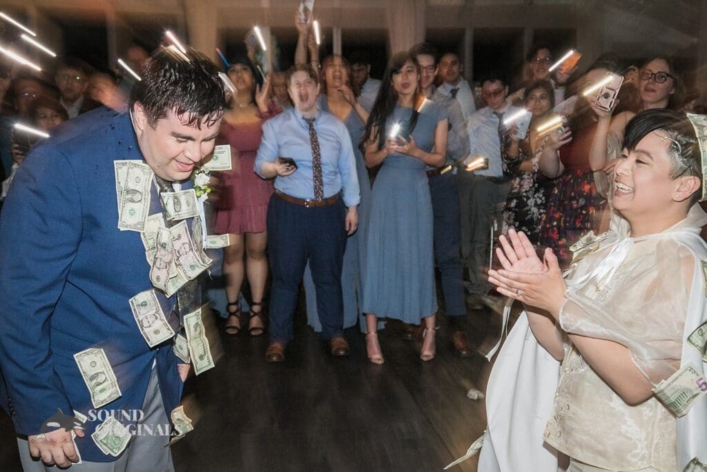 Bride and groom covered in dollars at their Monte Bello Estate Wedding reception