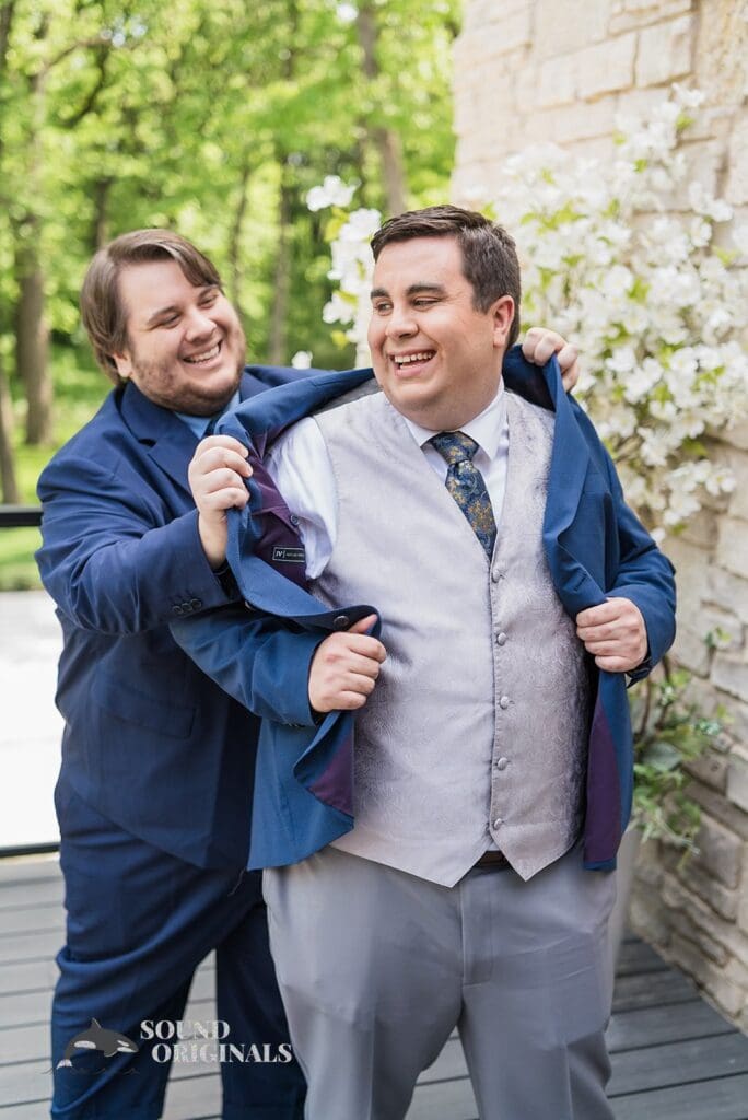 The groom getting help with his suit for his Monte Bello Estate Wedding