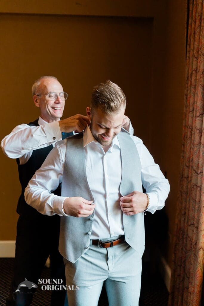 Royal Melbourne Country Club Wedding Relative helping the groom into his suit for his Royal Melbourne Country Club Wedding