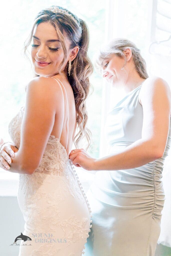 Royal Melbourne Country Club Wedding The bride getting buttoned up at her Royal Melbourne Country Club Wedding