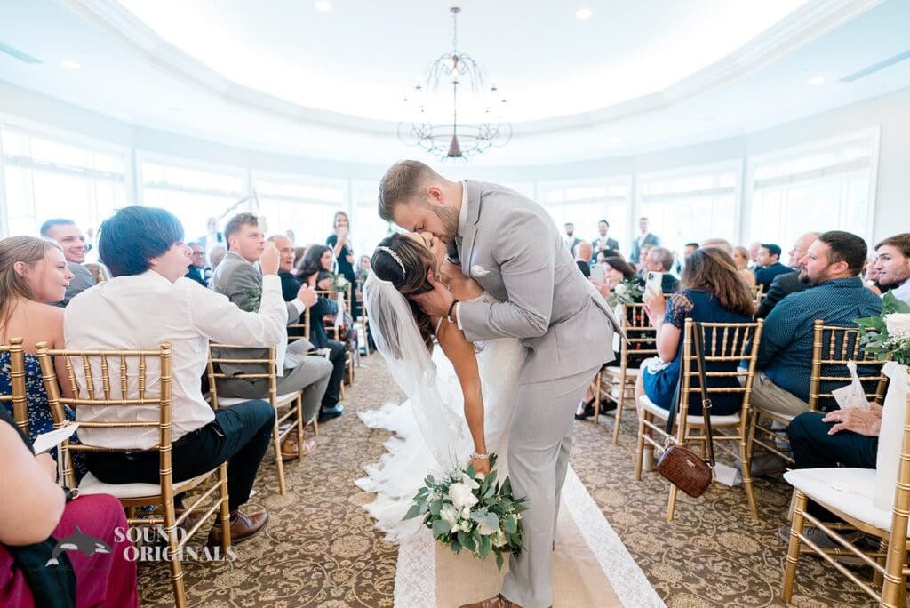 Royal Melbourne Country Club Wedding Bride and groom kiss in the aisle at their Royal Melbourne Country Club Wedding