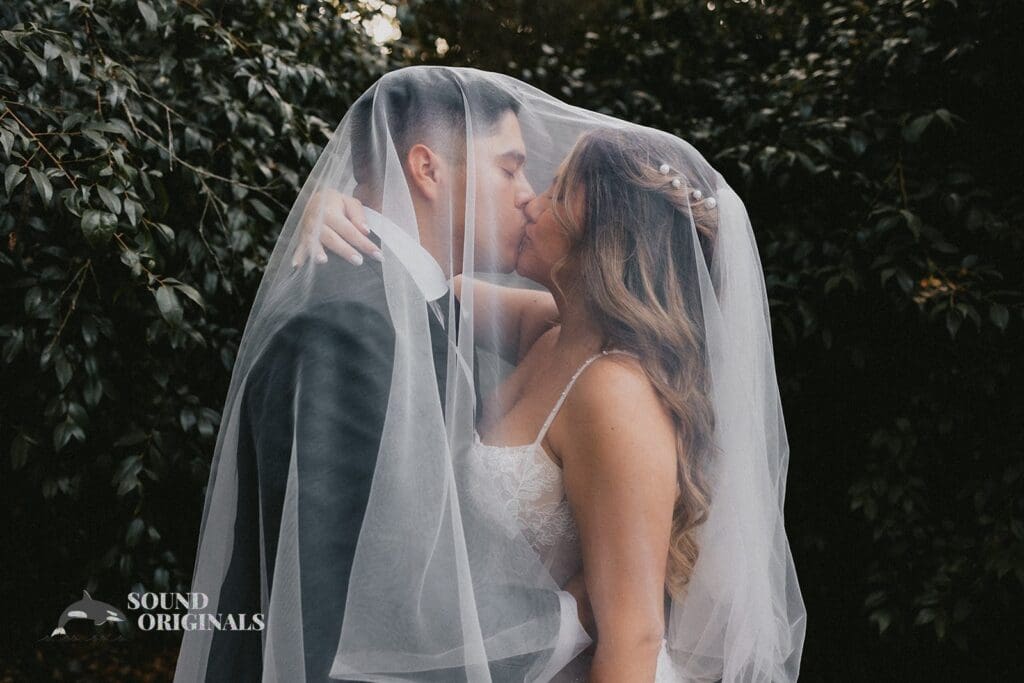 Bride and groom seal their marital vows with a passionate kiss in The Havens Country Club altar