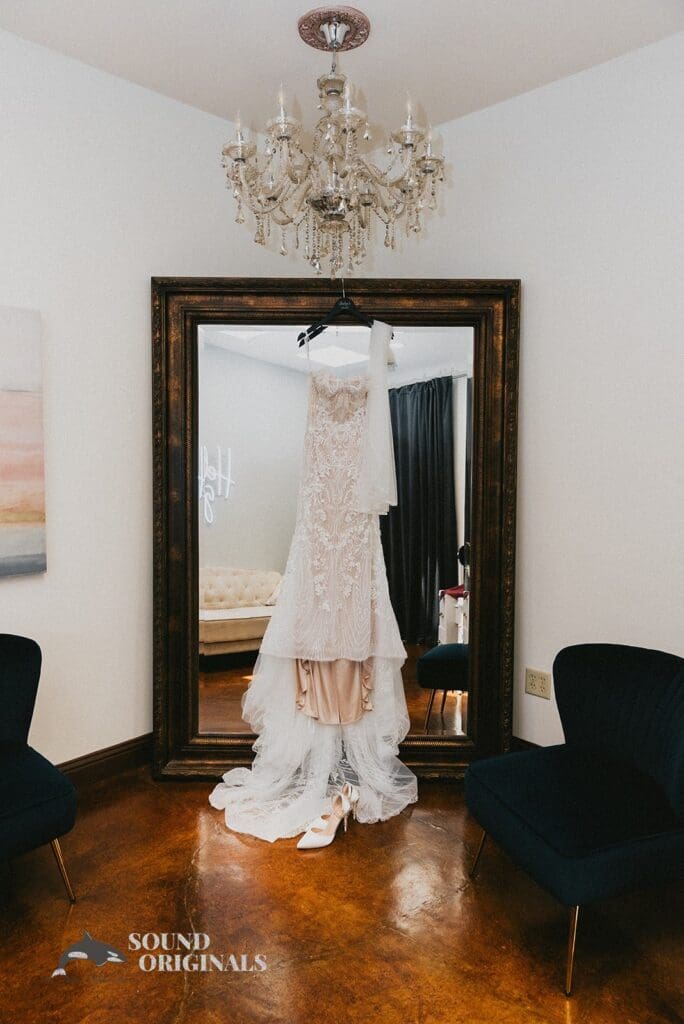 White dress hangs on mirror at Stoney Ridge Villa Wedding