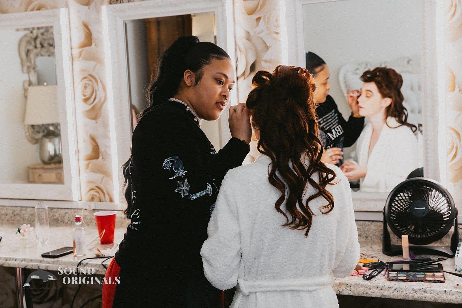 The bride getting her makeup done for her Stoney Ridge Villa Wedding