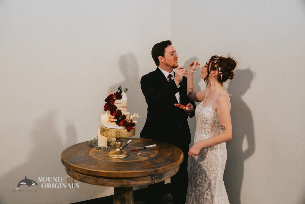 The happy couple eat their cake at Stoney Ridge Villa Wedding