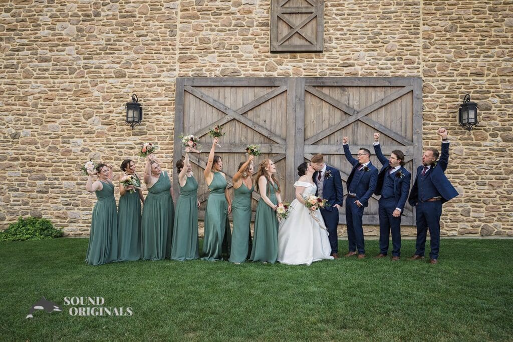 Wedding entourage cheering for the kissing couple at Folino Estate Winery